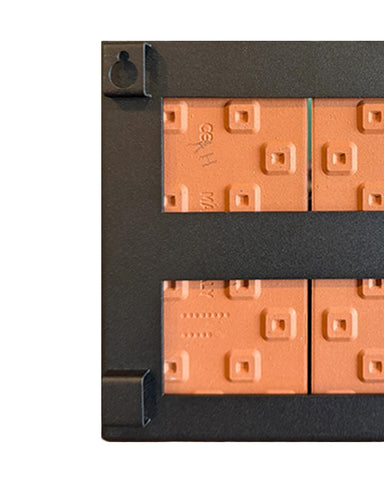 Close-up of a black frame with orange square blocks on a white background