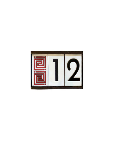 Decorative house numbers with numbers '12' and a red geometric pattern on a white background